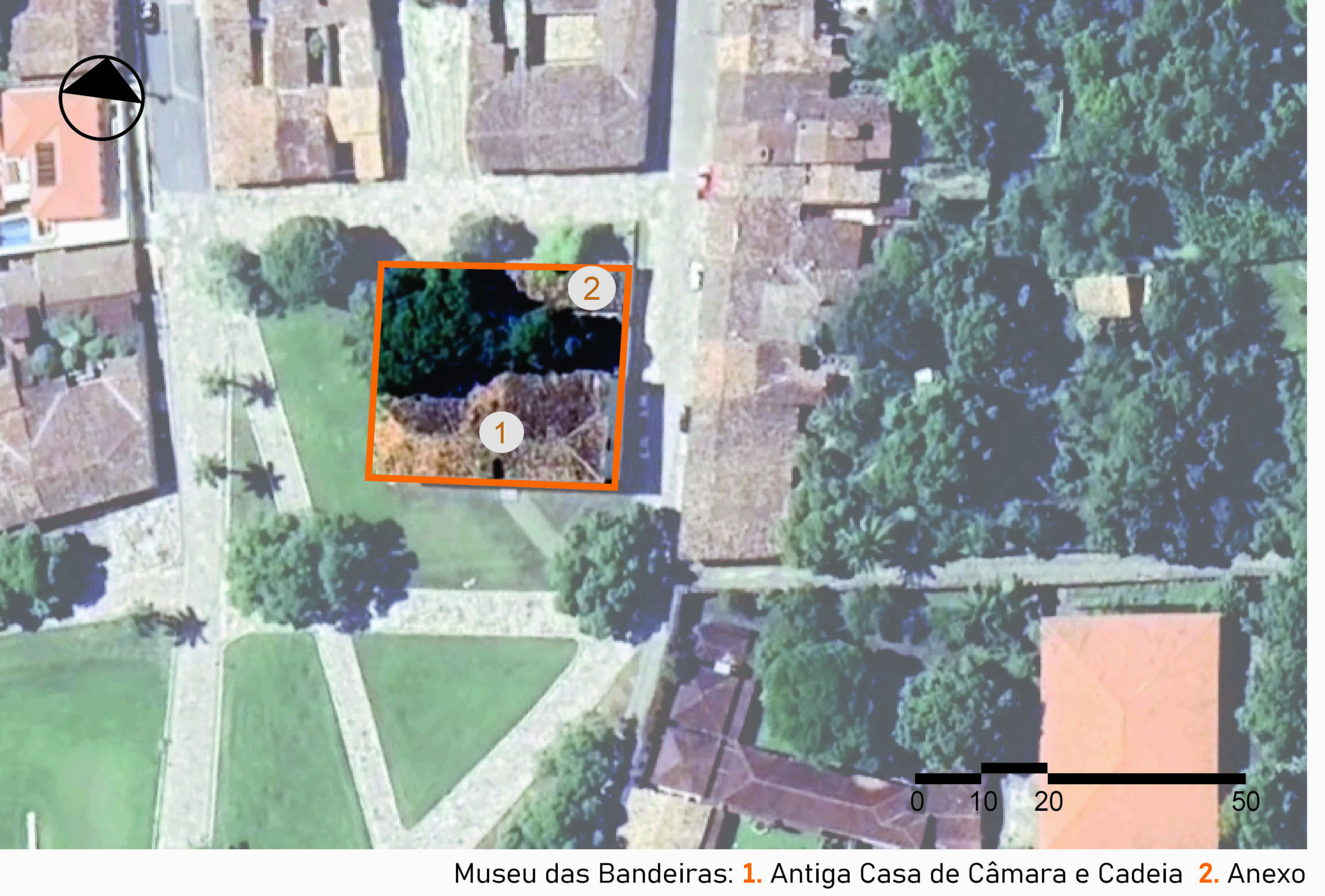 Vista aérea do museu localizado em uma área urbana com várias casas e árvores. No centro da imagem, um quadrado laranja destaca a propriedade que contém um edifício, um anexo e áreas verdes ao redor. Dentro do quadrado, há dois círculos numerados: o número 1, Antiga Casa de Câmara e Cadeia, e o número 2, anexo, sobre a área verde com árvores. A imagem inclui a legenda com a identificação das edificações, no canto inferior direito a escala gráfica e, na parte superior esquerda, uma seta indicando o ponto cardeal norte.